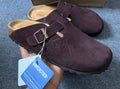 Stüssy x Birkenstock Boston Clog in the caramel or mocha suede colorway